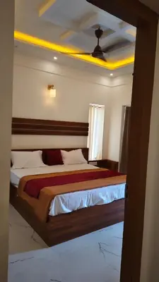 a bedroom with a large bed with a ceiling at Alora villas in Wayanad