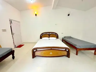 a bedroom with two beds in a room at The 77 Estate Stay in Suntikoppa