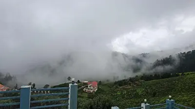a misty mountain with a house on a hill at Kalon Elpis Villa in Ooty