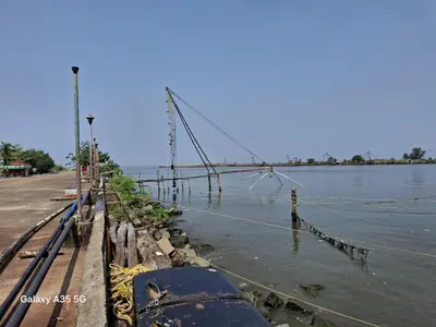 a bridge over the water next to a river at Aqua Vista beach home's in Cochin