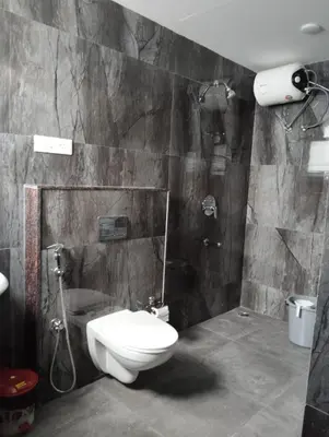 a bathroom with a toilet and a shower at Amaira Studio living - Coimbatore in Coimbatore