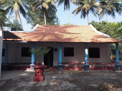 a small house with a straw roof and palm trees at Nalee Farm Stay in Hunsūr