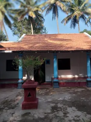 a house with a plant in a pot in front of it at Nalee Farm Stay in Hunsūr