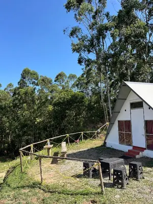 a small house with a picnic table in front of it at Vattavada budget cottages & Aframe in Vattavada