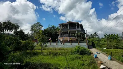 a house on the side of a road with a field at Azhagumail Honey Resort Kanthalloor in Kanthalloor
