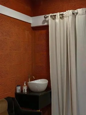 a bathroom with a white shower curtain and a sink at Rockview in Kalpetta
