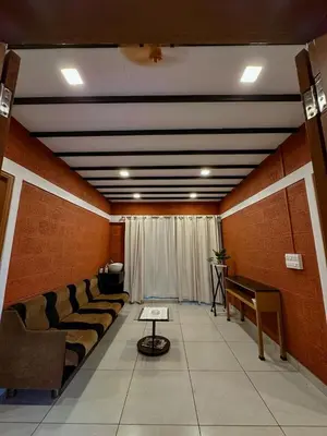 a waiting room with a row of couches and a table at Rockview in Kalpetta