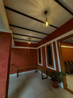a room with a bench in a building with a ceiling at Rockview in Kalpetta