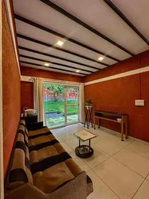 a living room with a couch and a piano at Rockview in Kalpetta