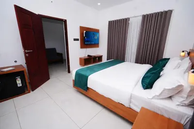 a bedroom with a bed and a television in it at Palm Wave Beach Resort in Cherai Beach