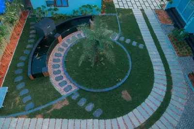 an overhead view of a garden with a palm tree at Palm Wave Beach Resort in Cherai Beach
