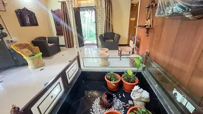 a view of a living room with plants on the floor at NATUREs LAP FARM STAY Mysore in Mysore