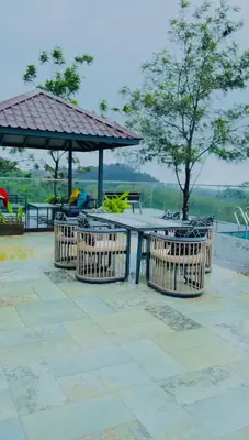 a picnic table with chairs and a gazebo at Vythiri Waves Resort l 3BR Private Pool Villa in Vayittiri
