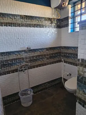 a bathroom with a toilet and a shower at Ahavah Chalets in Ketti