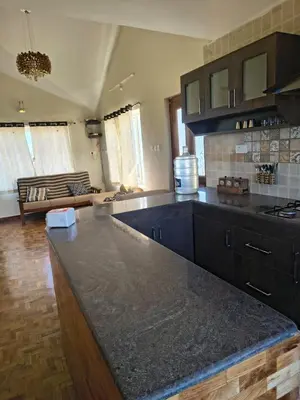 a kitchen with a large counter top in a room at Ahavah Chalets in Ketti
