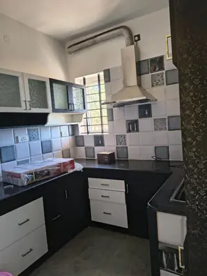 a kitchen with black and white tiles on the wall at Ahavah Chalets in Ketti