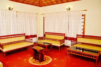 a room with four benches and a table at Hanging Huts Resorts in Kotagiri