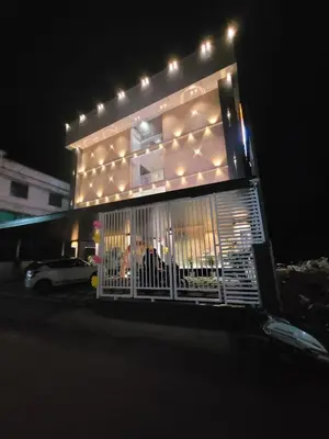 a building with a gate in front of it at night at Rajagiri View Apartments in Alwaye