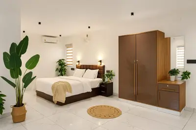 a bedroom with a large bed and a wardrobe at Rajagiri View Apartments in Alwaye
