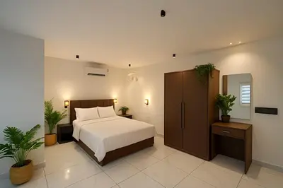 a bedroom with a bed and two potted plants at Rajagiri View Apartments in Alwaye