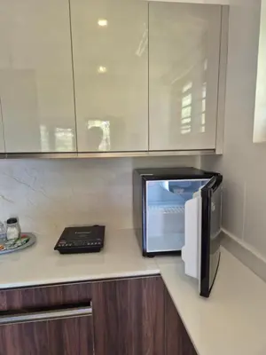 a microwave sitting on a counter in a kitchen at Prabhu Villla Upper Deck in Perumbavoor