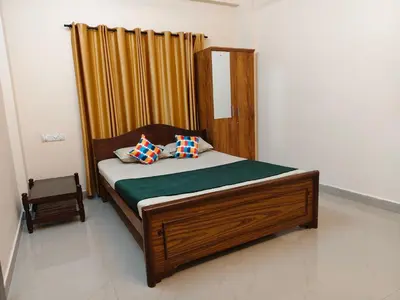 a bed with two pillows on it in a room at Sree manjulal Inn in Guruvāyūr