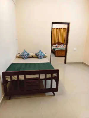 a bed in a room with a mirror at Sree manjulal Inn in Guruvāyūr