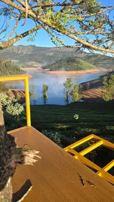 a view of a field with a view of a mountain at Silver lake nature escape in Ooty