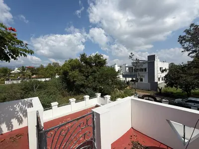 a white fence on the top of a building at Didan Stays in Coimbatore