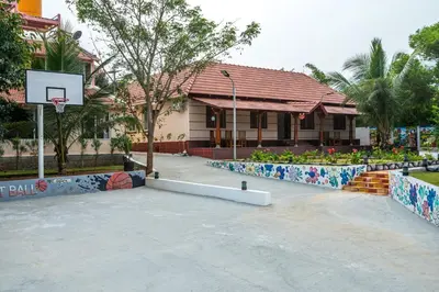 a basketball hoop in front of a building at Alaya Stays APR Pet-Friendly One-Room Suites with Swimming Pool in Bengaluru, Karnataka