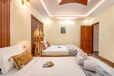 a bedroom with two beds and a lamp at Alaya Stays APR Pet-Friendly One-Room Suites with Swimming Pool in Bengaluru, Karnataka