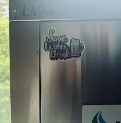 a sign that says save water drink on the side of a truck at Posh Holidays in Ooty