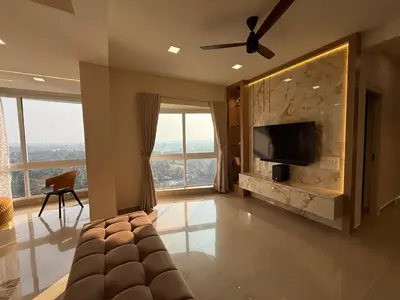 a large living room with a television and a couch at Dwaraka-Serene Riverfront 2BHK in Palakkad