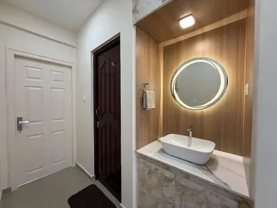a bathroom with a sink and a mirror at Dwaraka-Serene Riverfront 2BHK in Palakkad