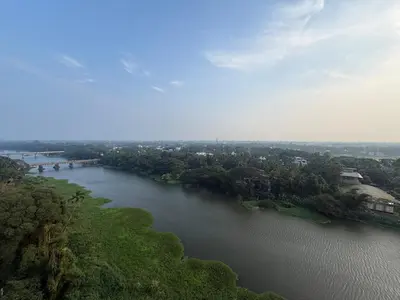 an aerial view of a river with trees and buildings at Dwaraka-Serene Riverfront 2BHK in Palakkad
