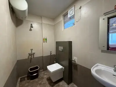 a bathroom with a toilet and a sink at Dwaraka-Serene Riverfront 2BHK in Palakkad