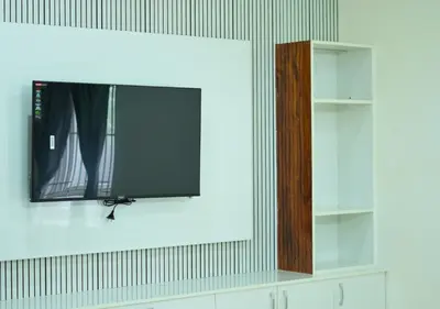 a flat screen tv hanging on a wall at Village Homestays By Adrta Groups in Marudhamalai