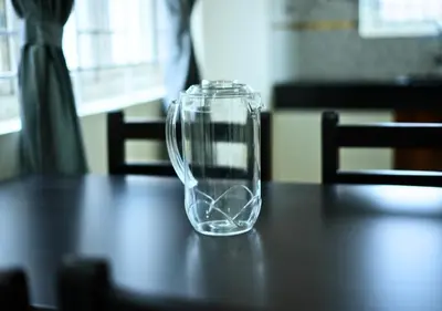 a glass vase sitting on top of a table at Village Homestays By Adrta Groups in Marudhamalai