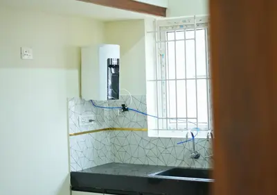 a kitchen with a sink and a window at Village Homestays By Adrta Groups in Marudhamalai