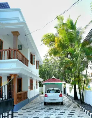 a car parked in front of a house at White Haven in Angamali