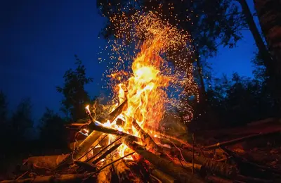 a bonfire with sparks in the night at amã Stays & Trails - Wentworth Estate Villa, Tamilnadu in Cherambādi