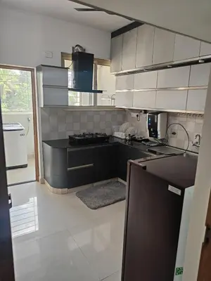 a kitchen with a black counter top and a stove at Aapt green field in Trichūr