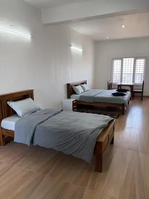 a room with three beds in a room at Kerith in Kodaikānāl