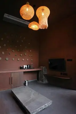 a living room with two lights and a tv at Ayana Villa By KPM in Varagampadi