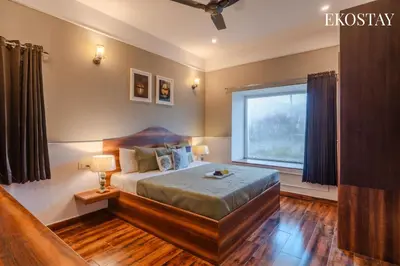 a bedroom with a large bed and a window at EKOSTAY - Helios Villa in Kodaikānāl