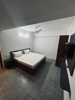 a bedroom with a bed and a tv in it at hotel sri kaliappaa in Coimbatore