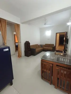 a living room with a couch and a tv at 1bhk Kalp Guruvayur 150m to temple in Trichūr