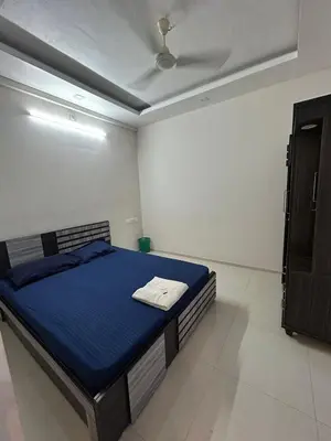 a bedroom with a blue bed in a room at 1bhk Kalp Guruvayur 150m to temple in Trichūr