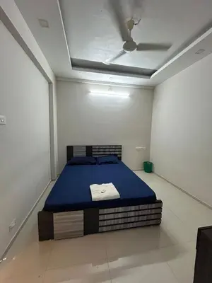 a bedroom with a bed in a room with a ceiling at 1bhk Kalp Guruvayur 150m to temple in Trichūr