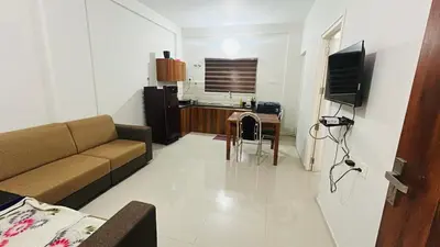 a living room with a couch and a table at 1bhk Kalp Guruvayur 150m to temple in Trichūr